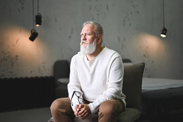 Elegant senior man sitting on chair.