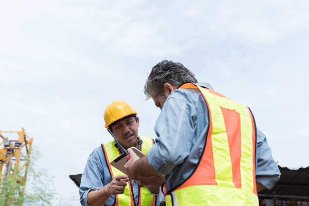 istock Team of male engineer construction using digital tablet for discussing of structure of building at construction site. Group of male construction builder working at construction site 2171613003