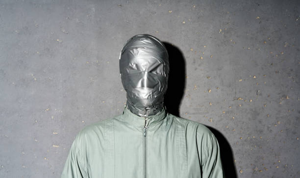 istock Mystery man with duct tape face wrap on gray background 2171613373
