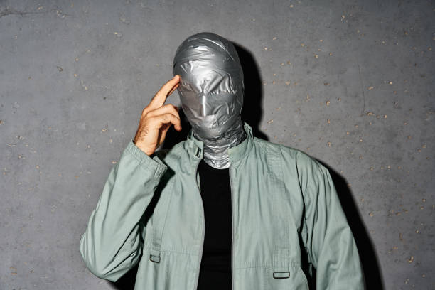 istock Mystery thoughtful man with duct tape face 2171613382