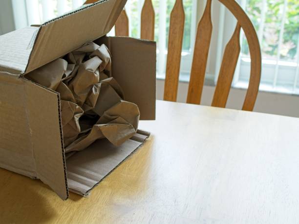 istock Emptied cardboard box on table in domestic room 2171613783