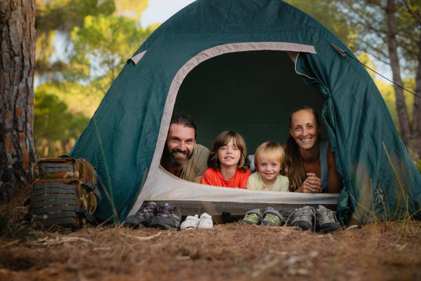 istock Happy family camping smiling inside tent in the forest 2171614699