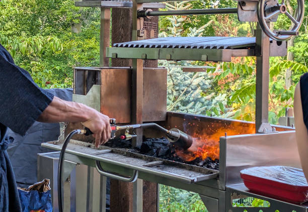 A blast of flames heats a barbecue on a terrace in Ontario. Food preparation at a family summer potluck.