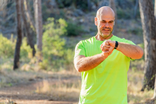 istock Man connecting the smart watch, in the forest 2171614919