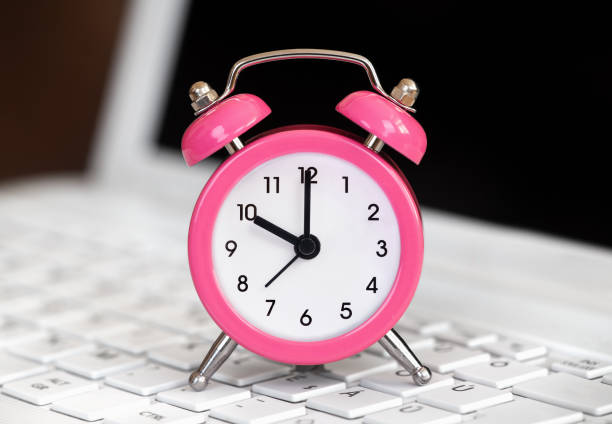 istock Alarm clock on a laptop keyboard, daylight savings time 2171615382