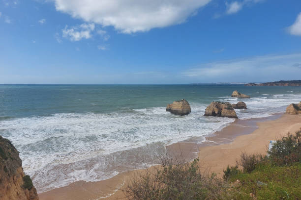 istock Serene Beachscape with Rocky Outcrops and Blue Sky 2171615844