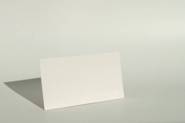 istock White blank business card on brown paper background with soft shadow. 2171615848