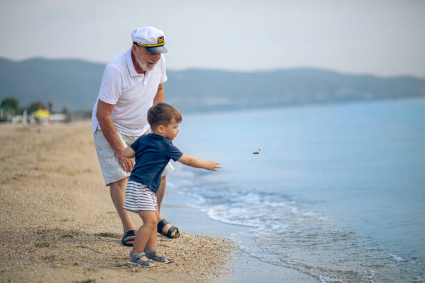 istock Happy kid playing on the beach with his grandfather 2171615853
