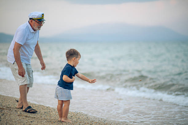 istock Happy kid playing on the beach with his grandfather 2171616068