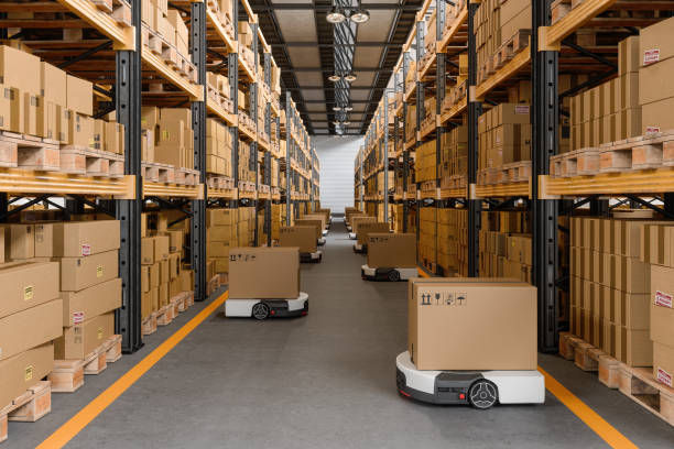 istock Warehouse Interior With Automated Guided Vehicles Carrying Cardboard Boxes 2171616154