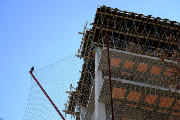 View of the exterior of a building under construction, covered with security coating. A building renewed with urban transformation.  Construction industry, economic data. Housing prices.