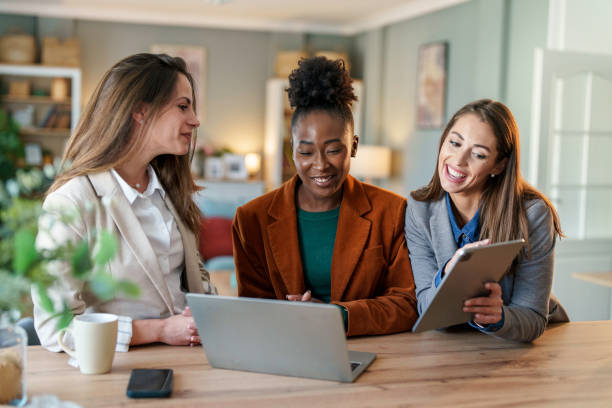 istock Multicultural Businesswomen Engaging in Teamwork by a Laptop 2171618138