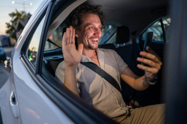 istock Man in back seat of a car using his smartphone 2171618422