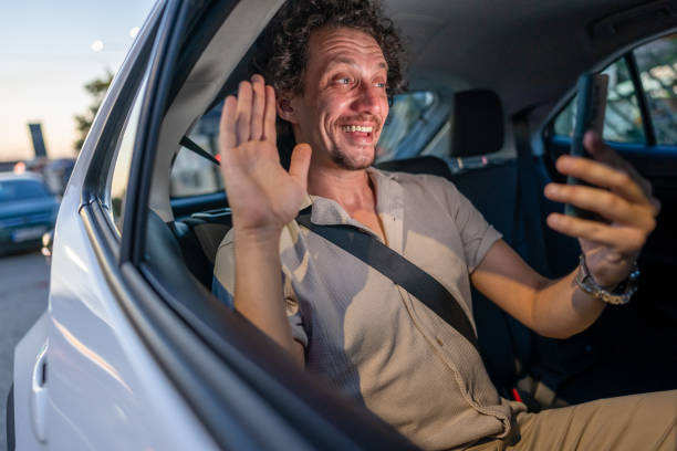 istock Man in back seat of a car using his smartphone 2171618498