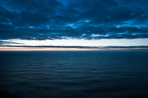 istock Sunset over the Pacific Ocean during a cloudy evening 2171618509