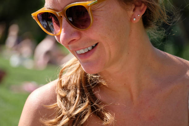 A pretty party woman buried up to her head on a beach