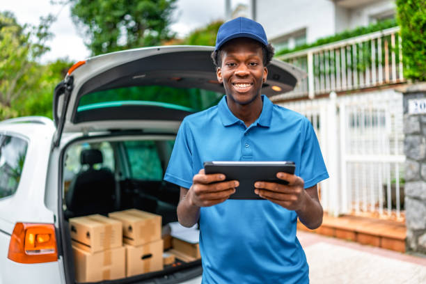 istock African young courier using digital tablet to deliver packages 2171619696