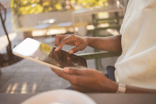 istock Person using a digital tablet in an outdoor setting 2171619937