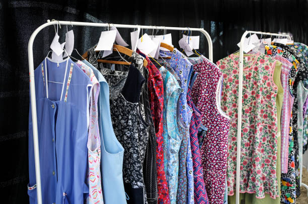 istock Various smock aprons or hooverettes on clothes rails, in Germany called Kittelschurze, formerly worn by women for housework and gardening 2171621233