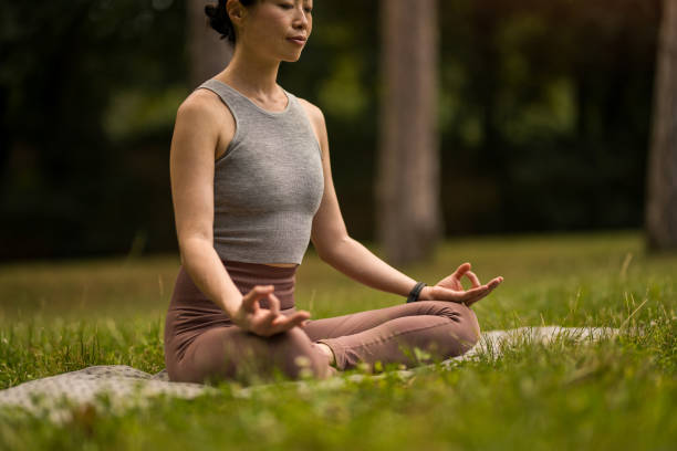 istock Woman meditating in nature. 2171622298