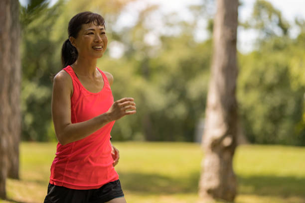 istock Athletic Asian woman running in nature. 2171622433