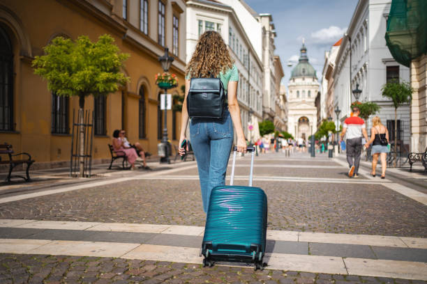 istock A traveler strolls through the charming streets of Budapest, pulling a suitcase under the warm sunlight on a vibrant afternoon 2171623401