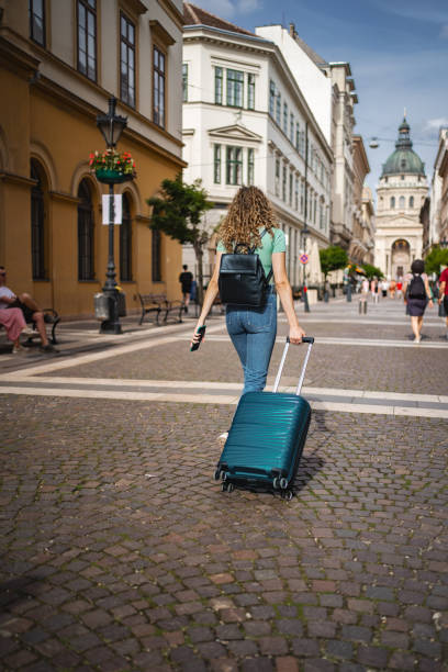 istock Exploring the charming streets of Budapest while rolling a suitcase on a sunny day in the historic city center 2171623456