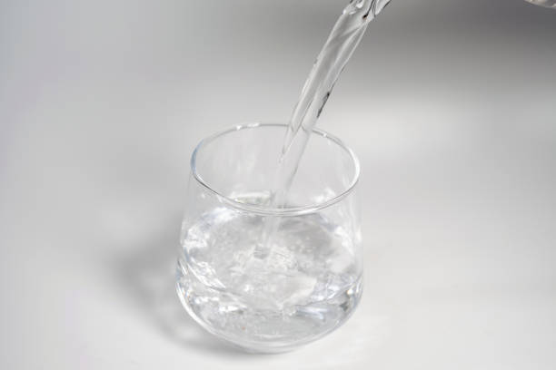 istock Pour Water Into Empty Glass Isolated On White Background 2171623875