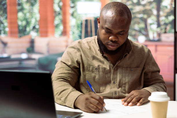 istock Entrepreneur reviewing blueprints and adding rooms measurements 2171625524