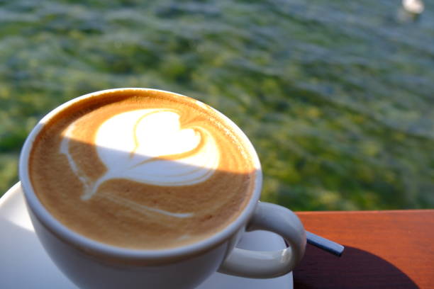 istock Cafe latte in a coffee cup by the sea 2171632894
