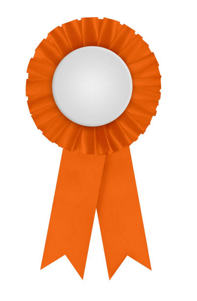 Rosette - red winners prize ribbon. Circular pleated first place award with blank white center to place a design on. Photographed isolated on a blank white background.