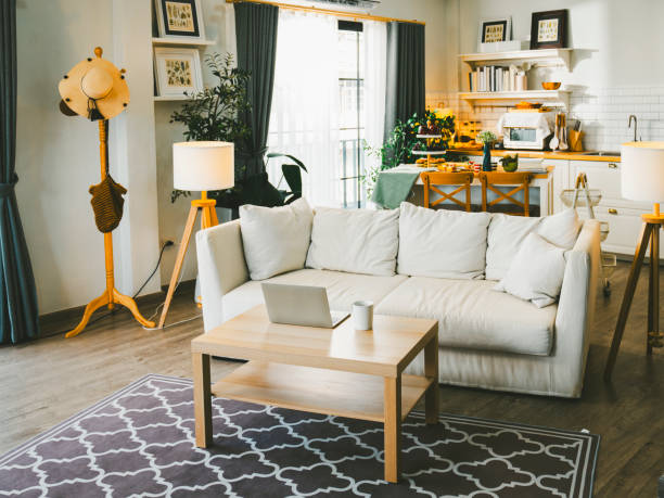 istock Sofas and tables in a cozy home with a kitchen in the background. 2171633702