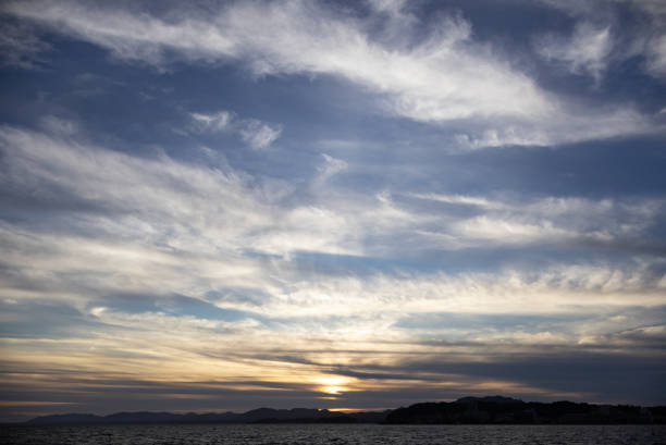 A beautiful sunset scene on the lake in Japan, with a pine tree silhouette.