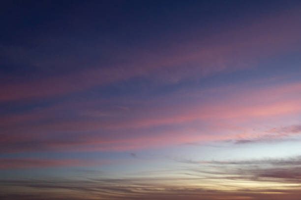 Some lines of beautiful clouds of pink color in the blue sky