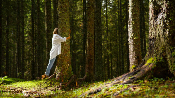 istock Caucasian Woman Hugging Tree in Forest 2171639498