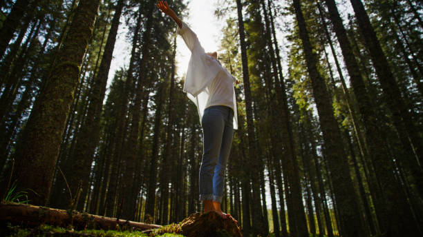 istock Woman Balancing on Tree Stump in Forest 2171639526