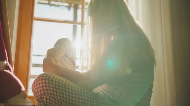 istock Tender Mother Child Embrace at Home During Sunset 2171639792