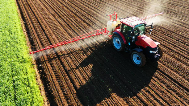 istock Tractor Fertilizing Agricultural Field 2171639908