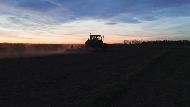 istock Nighttime Agriculture Tractor Plowing Field 2171639953