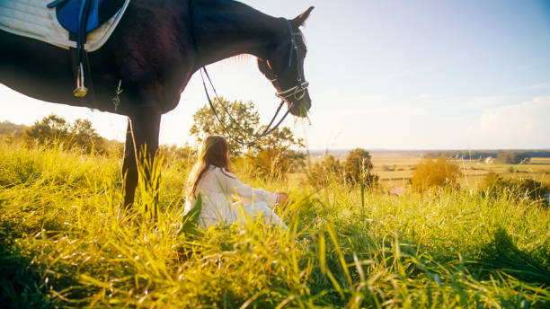 Mature female horse rider with her horse