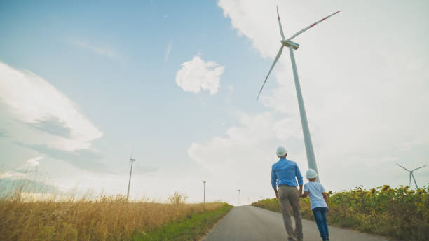 istock Engineer Father and Son Studying Wind Turbines in Field 2171640518