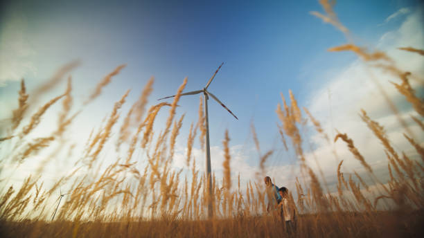 istock Caucasian Father and Son Observing Wind Turbines 2171640530
