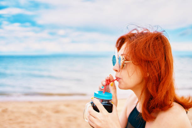 istock Enjoying a Relaxing Beach Day While Sipping on a Refreshing Drink Under the Sunshine 2171642196