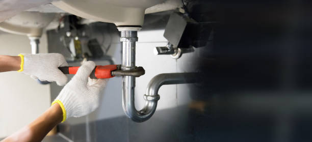 istock Technician plumber using a wrench to repair a water pipe under the sink. Concept of maintenance, fix water plumbing leaks, replace the kitchen sink drain, cleaning clogged pipes is dirty or rusty. 2171646693