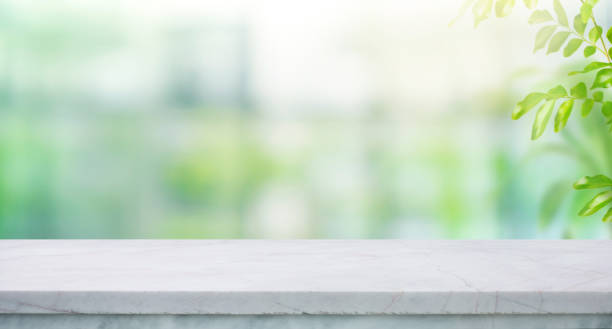 istock Selective focus.Elegance product display background with marble top on blur big window and fresh garden 2171649993