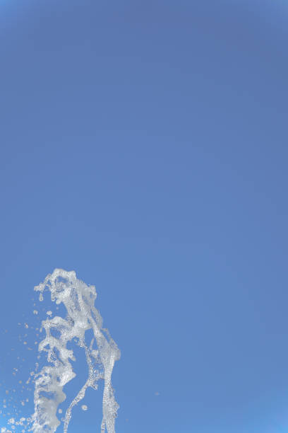 water jet with foam on a blue sky background
