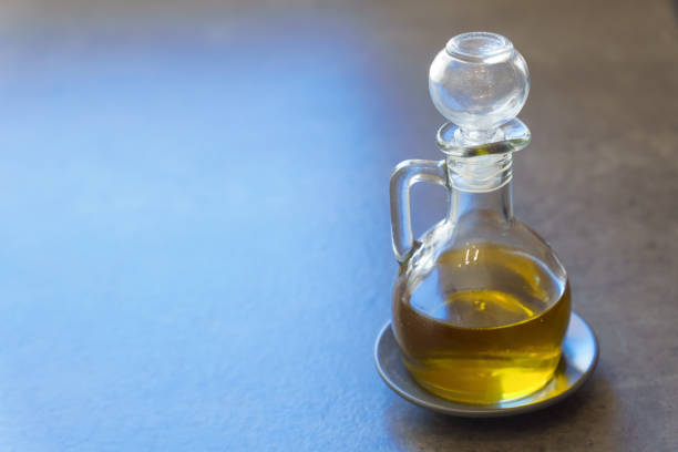 A woman shows a bottle of Italian olive oil