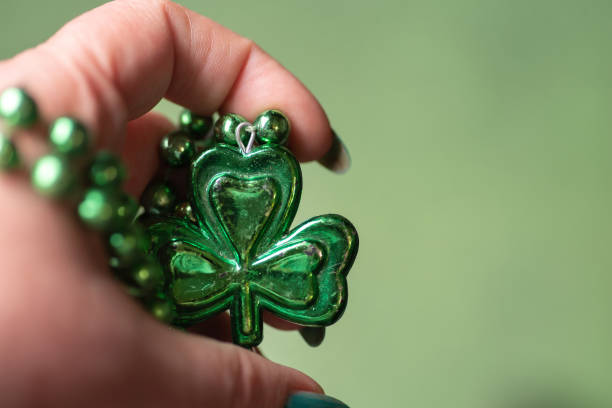 A heart with lucky clovers is clinging to a rope