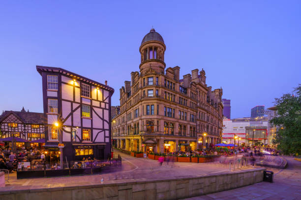 Manchester UK - October 08, 2022: Sunset scene of the Exchange Square, with local businesses, locals, and visitors, in Manchester, England, UK
