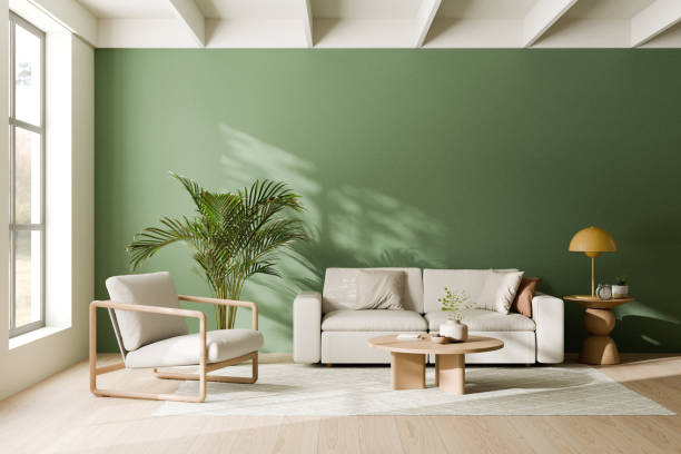 istock Modern living room featuring a green accent wall, a comfortable beige sofa with cushions, a wooden coffee table, and an elegant wooden armchair beside a large indoor plant. 3d render. 2171657368